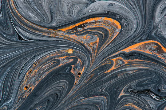 Dark abstract fluid painting featuring rich black, grey, and vibrant bright orange swirled patterns.