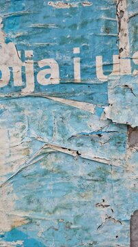 Time-lapse of an old torn and ripped street poster background, messy and weathered paper art collage