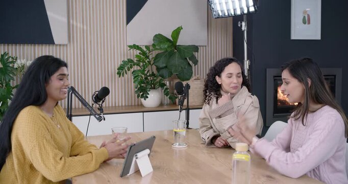 Diverse female hosts in mustard knit beige trench hosting podcast after mic check using mics