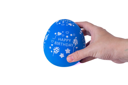 Hand holding a blue egg shaped kitchen timer isolated on white background