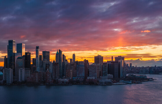 UNITED STATES, NEW YORK CITY. AERIAL VIEW OF LOWER MANHATTAN SKYLINE AT SUNRISE WITH FINANCIAL DISTRICT AND BATTERY PARK SKYSCRAPERS