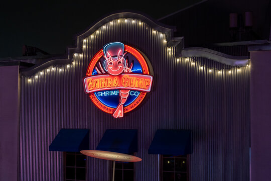 Orlando, Florida,  USA - February 6, 2022: The illuminated neon sign for a Bubba Gump Shrimp Co restaurant on the building. Orlando, Florida,  USA. Bubba Gump Shrimp Co is an American seafood restaura