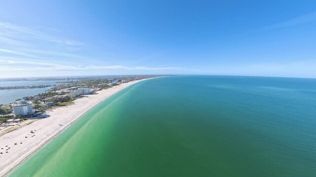 Travel and Tourism: 4K Aerial Drone View of the White Sand Beach, Waves, and Oceanfront Resorts at St. Pete Beach, Florida