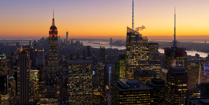 UNITED STATES, NEW YORK CITY, MANHATTAN. NEW YORK CITY AERIAL VIEW OF MIDTOWN SKYSCRAPERS AND HUDSON RIVER AT SUNSET