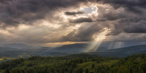 Fototapeta premium Dramatic Storm Clouds Over rolling Green Hills Landscape