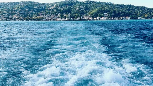Captivating texture of thick white sea foam and splashing currents in the deep Bosphorus Strait, Istanbul. Powerful aquatic motion and churning sea water background for marine design concepts.