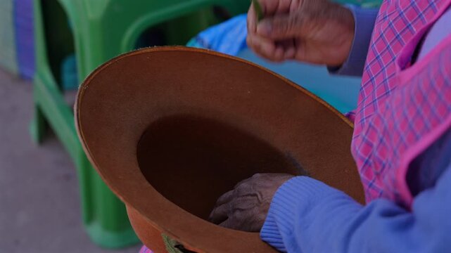 Andean Woman Holding Traditional Coca Leaves