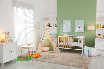 Cute baby room interior with comfortable crib, wigwam and other toys © New Africa