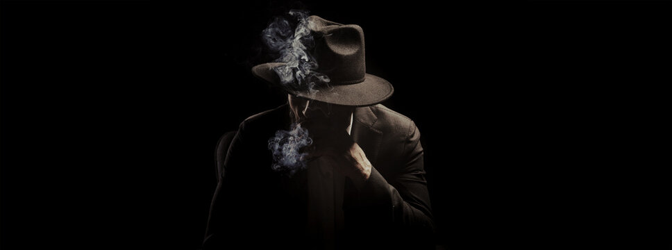 Mafia. Man in hat smoking cigar against dark background, banner design