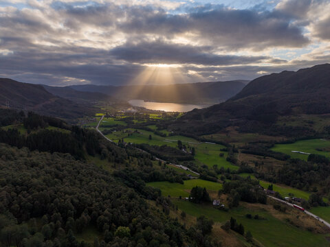 Dramatic Sun Rays Over Green Norwegian Valley and Fjord