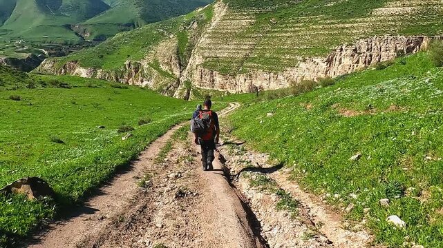 Irbid, Jordan : A group of athletes hiking between mountains and plants to reach the Al-Arais pond, near the Jordanian border