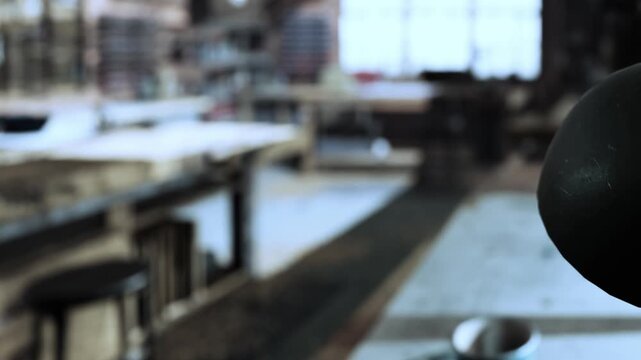 Sunlight filters through large windows in a rustic workshop where tools and materials are arranged for creative projects. The atmosphere is vibrant with inspiration and craftsmanship.