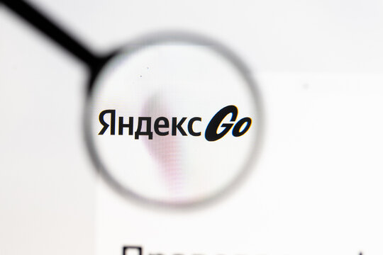 Milan, Italy 2026, 15 AGO Closeup of Yandex Taxi website page on a laptop screen. Focus on Yandex Taxi logo under a magnifying glass.