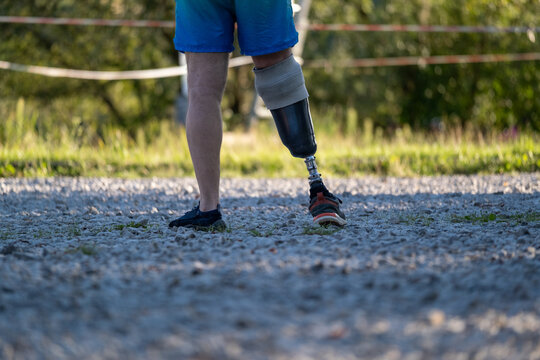 Person with below knee prosthetic leg walking outdoors. Walking Toward Independence With a Lower Limb Prosthesis