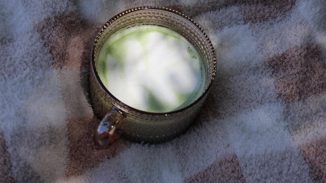 matcha latte in a beautiful glass on a sunny day
