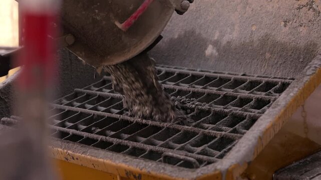 Concrete transferred from mixer into concrete pump receiving hopper