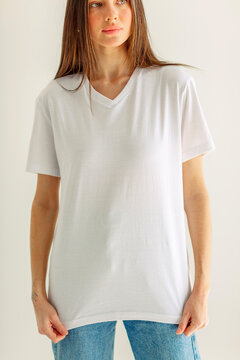 Blank white t shirt on a torso with the head out of frame