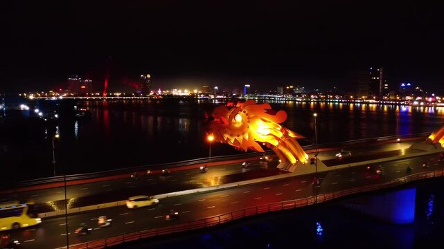 Dragon Bridge over the Han River at Night in Da Nang, Vietnam &ndash; Aerial View of Illuminated Dragon Sculpture, City Skyline and Traffic Reflections