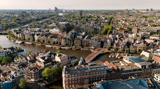 Sweeping aerial view of Amsterdam canal houses beside the Amstel River