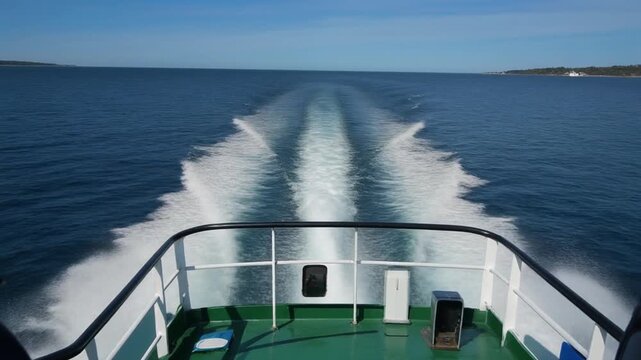 Ferry wake and narragansett bay view under clear blue sky