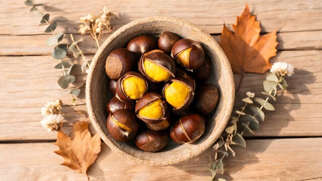 Roasted Chestnuts in a Bowl with Autumn Leaves