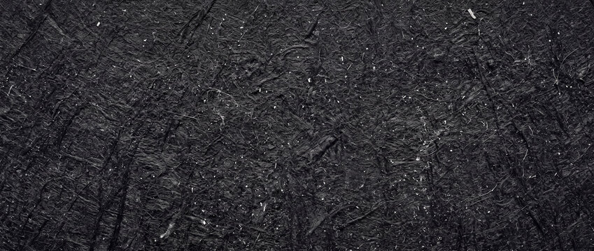 Black mulberry paper texture, dark handmade fibrous background, rustic charcoal textured surface for elegant design backdrops