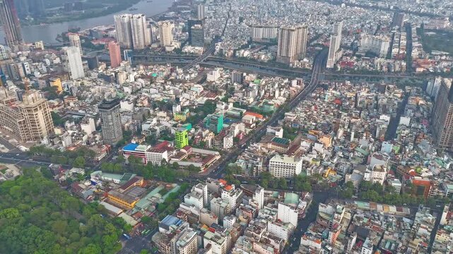 High-angle aerial hyperlapse overlooking 23-9 Park, busy, dense city traffic around Quach Thi Trang roundabout and modern skyscrapers in central District 1, Ho Chi Minh City, Vietnam