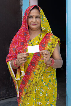 Indian rural poor woman showing aadhar card a government ID. People or citizen election of india