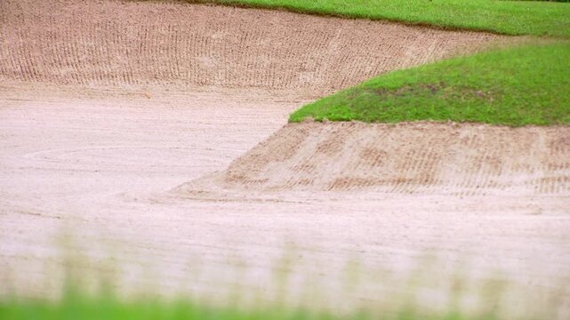 Low angle shot of a golf course sand trap background, blurred focus.
