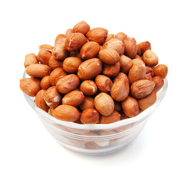 Dried peanuts in closeup on white