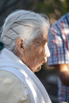 Close up photography of an elderly person outdoors on a sunny day