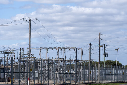 Electrical substation infrastructure with utility power poles, transformers, metal lattice framework. Regional electrical distribution, power grids. Bacchus Marsh, Victoria, Australia