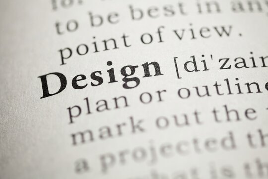 Macro closeup of dictionary page highlighting the definition of the word design with dictionary