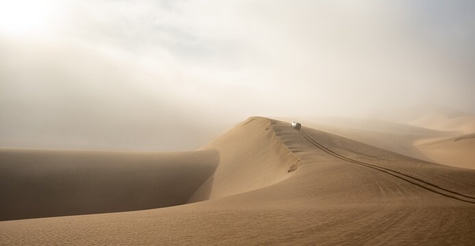 Off-road vehicle between high dunes, sea of dunes, Sandwich Harbour, impressive desert landscape, Namib Naukluft Park, Namib Desert, Namibia