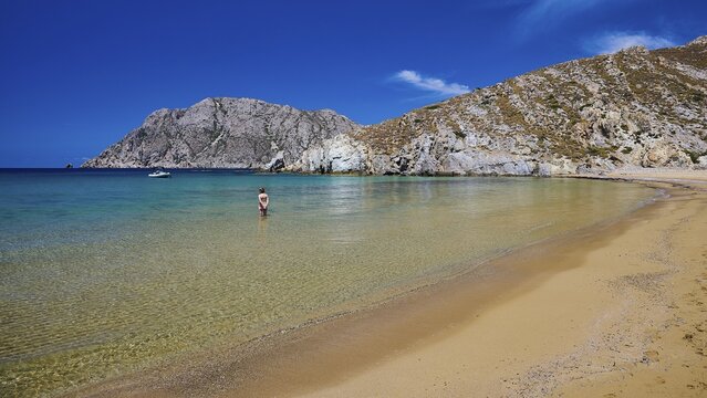 A quiet beach with turquoise waters, surrounded by mountains under a clear sky, Psili Ammos Srand, Patmos, Dodecanese, Greek Islands, Greece