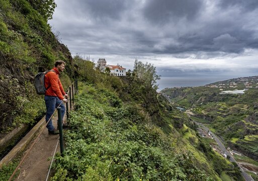 Hiker on footpath, Levada do Moinho, Ponta do Sol, Madeira, Portugal