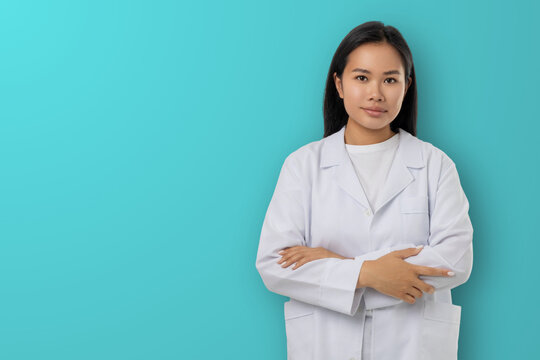 Woman stands with arms crossed in a medical outfit