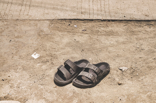 Black rubber sandal in sand