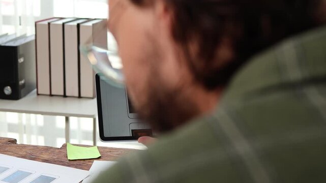 Creative team of ux ui designers brainstorming and collaborating on mobile application design, using a digital tablet and discussing user interface wireframe layout at the office