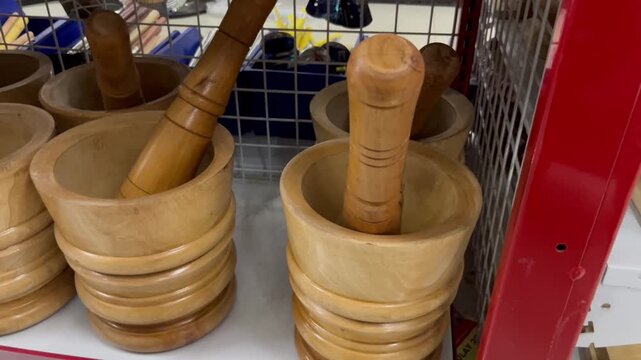 Traditional wooden mortar and pestle displayed on a store shelf