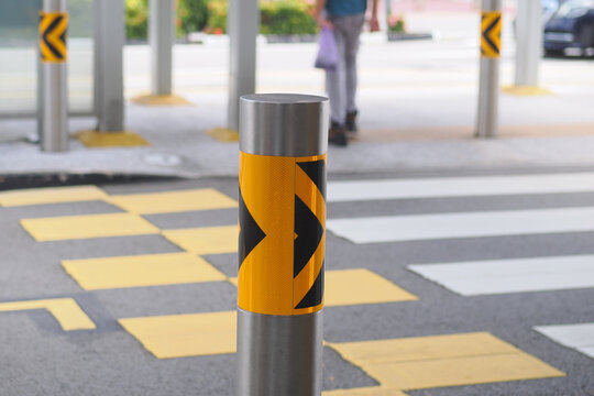 Traffic pole with warning markings on street