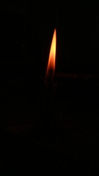 burning candle in the dark