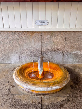 A fountain in Karlovy Vary offers mineral water. The spot shows the various textures and colors of the fountain's surface. Spring 2, Charles IV Spring, Pramen Karla IV in Market Colonnade