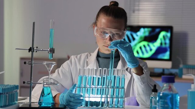 Female geneticist scientist analyzing DNA samples in a futuristic genetics research laboratory, a woman chemist working with test tubes developing a new vaccine or drug