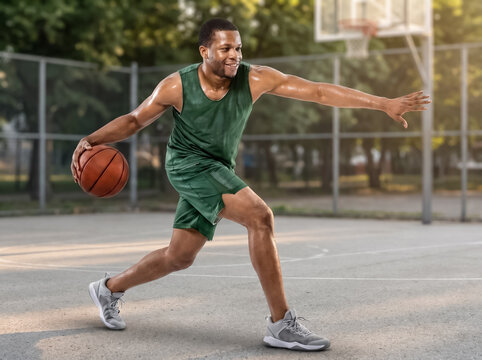 Basketball player dribbling on outdoor court