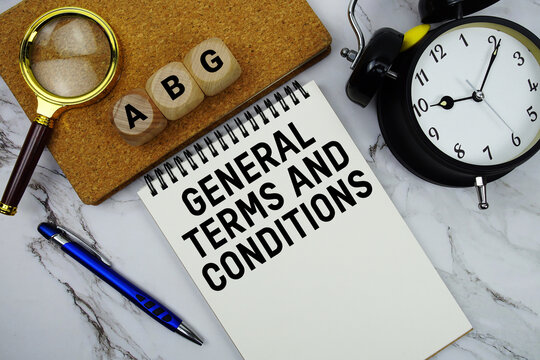 AGB General Terms and Conditions text written on notepad with magnifying glass and alarm clock on marble background