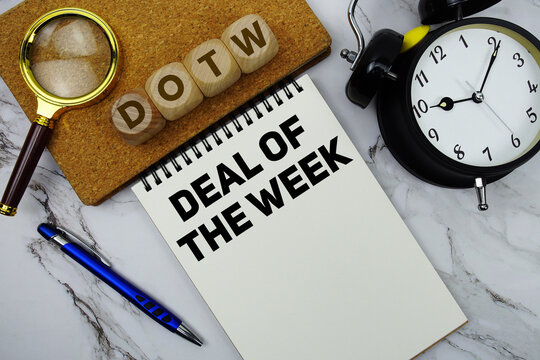 DOTW Deal of the Week text written on notepad with calculator and magnifying glass on marble background