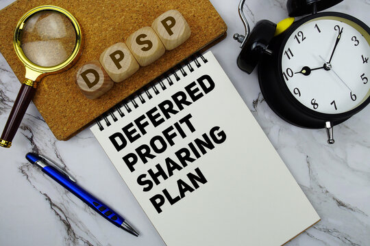 DPSP Deferred Profit Sharing Plan text written on notepad with calculator and magnifying glass on marble background