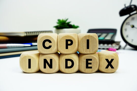CPI Index alphabet letters with calculator and alarm clock on white background