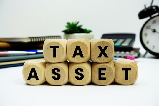 Tax Asset alphabet letters with calculator and alarm clock on white background